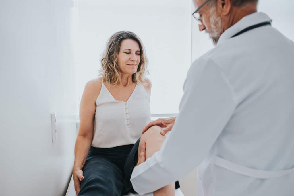 Patient with knee pain in doctor's office